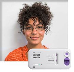 Patient with a Visby Medical Sexual Health Test device with her results.