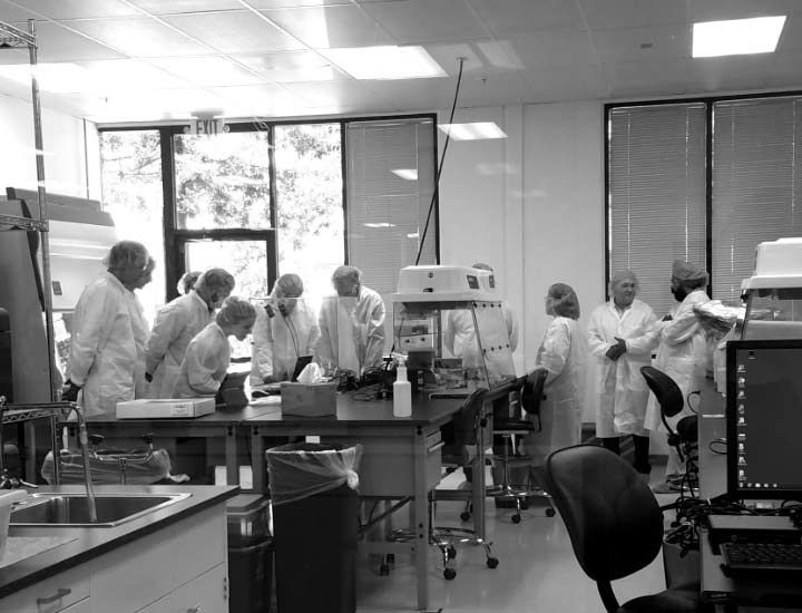 Technicians having a meeting in a laboratory.
